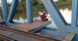 A man sits on Blue Nile Bridge in Khartoum  where several peaceful protesters were killed by security agencies in June 2019
