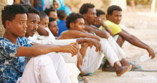 Eritrean migrants sit at the Wadi Sherifay camp on May 2, after being caught by Sudanese border security illegally crossing the Eritrea-Sudan border in the eastern Kassala state. (AFP)