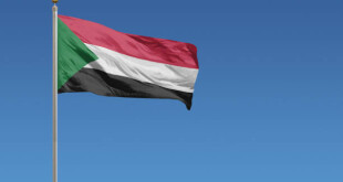 Flag of Sudan in front of a clear blue sky